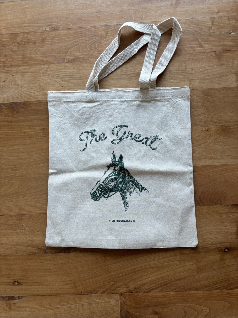 THE GREAT. Natural Canvas Tote in Cream with Dark Green Print